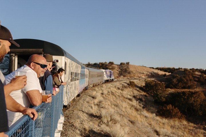 a man standing next to a train