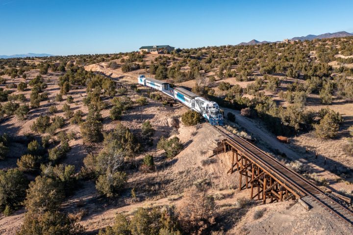 a train traveling down a dirt road