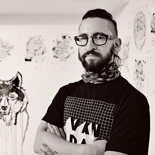 a man wearing glasses posing for the camera