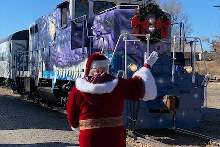 a person standing next to a train