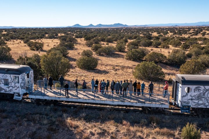 a train traveling down a dirt road