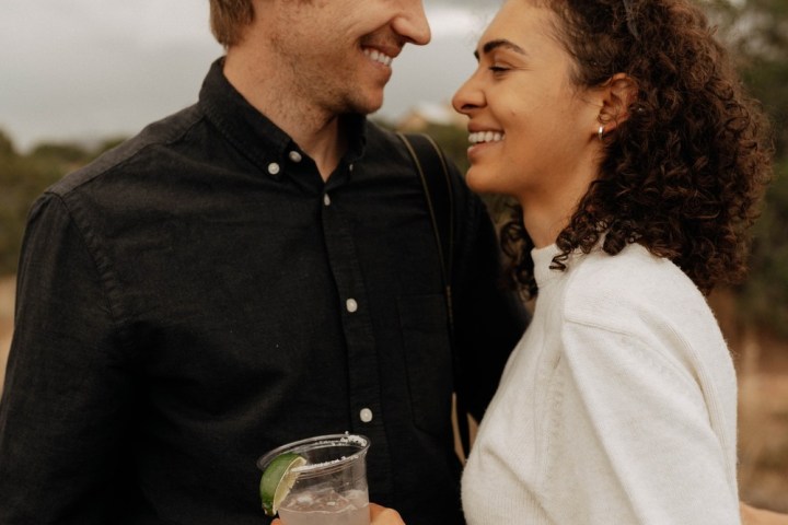 a man standing next to a woman