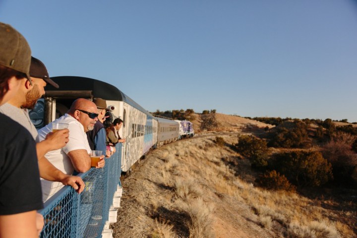 a man standing next to a train