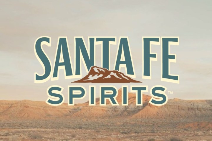 Santa Fe Spirits logo over a desert landscape.